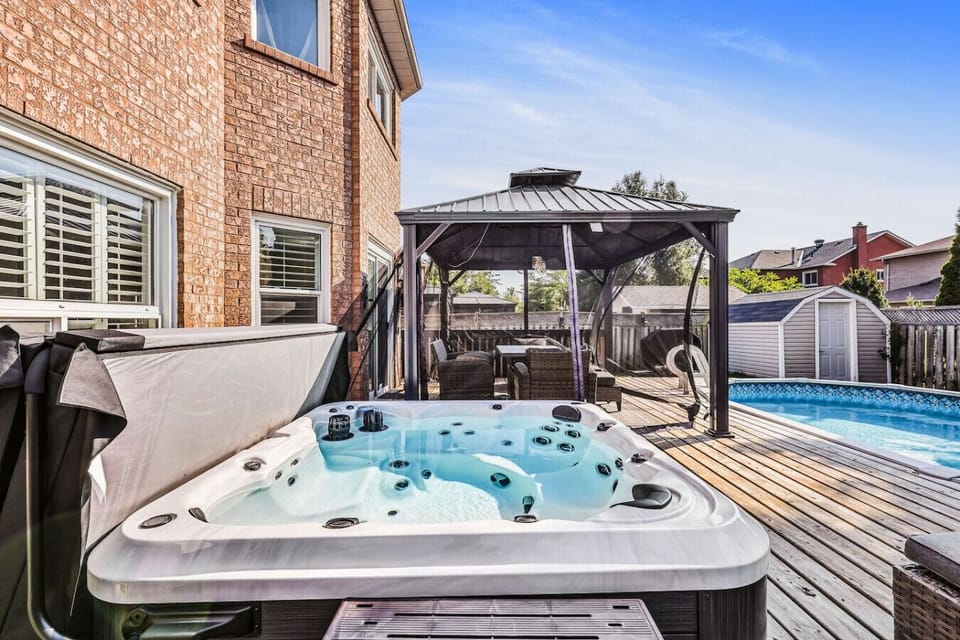 A sun-drenched sanctuary with a soothing hot tub, shaded lounge area, and sparkling pool. Escape the everyday and step into your private retreat. Perfect for relaxation and fun.