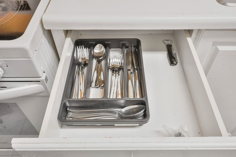 Every detail is covered. Enjoy pristine, full sets of cutlery and a bottle opener, perfectly organized and ready for all your dining needs during your stay in our well equipped kitchen.