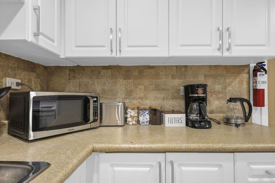 Start your day right with our coffee station, complete with a drip coffee maker and kettle. Plus, a microwave and toaster are ready for quick meals and snacks. Convenience is key.