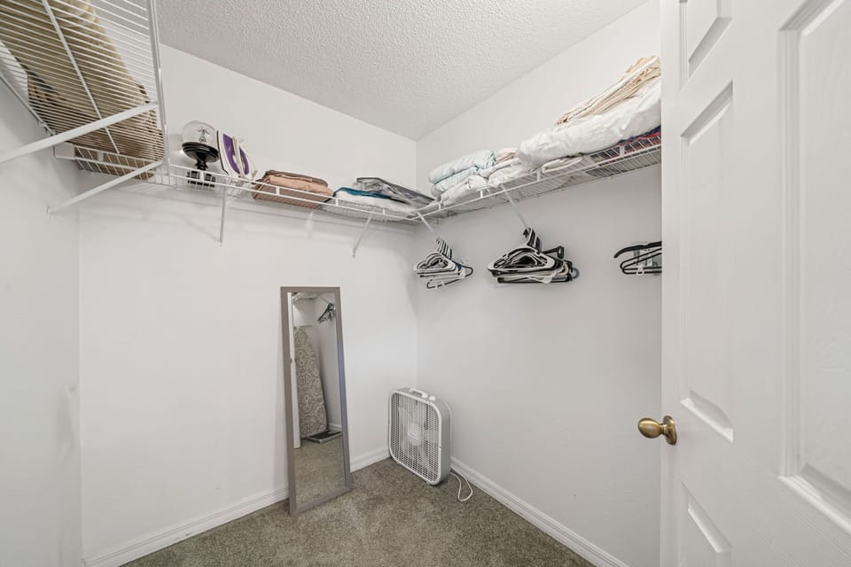 Large walk-in closet with organized shelving — perfect for long Orlando stays