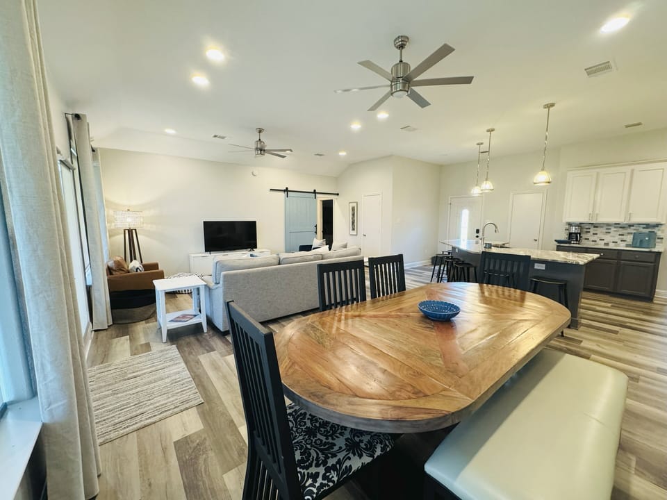 Open concept layout with dining table for 7, great for meals and game nights.