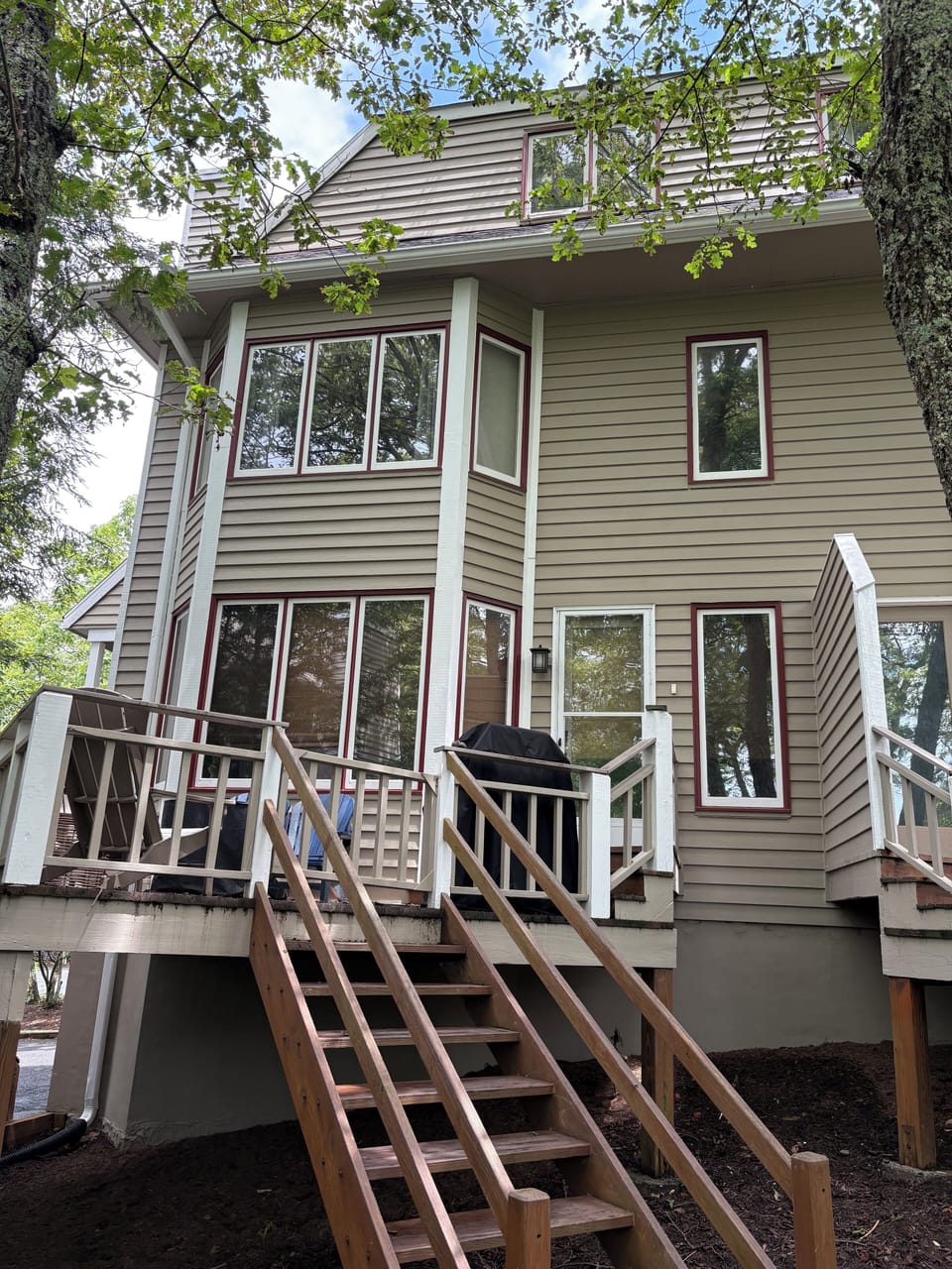 Back deck with seating, gas firepit, and weber grill.