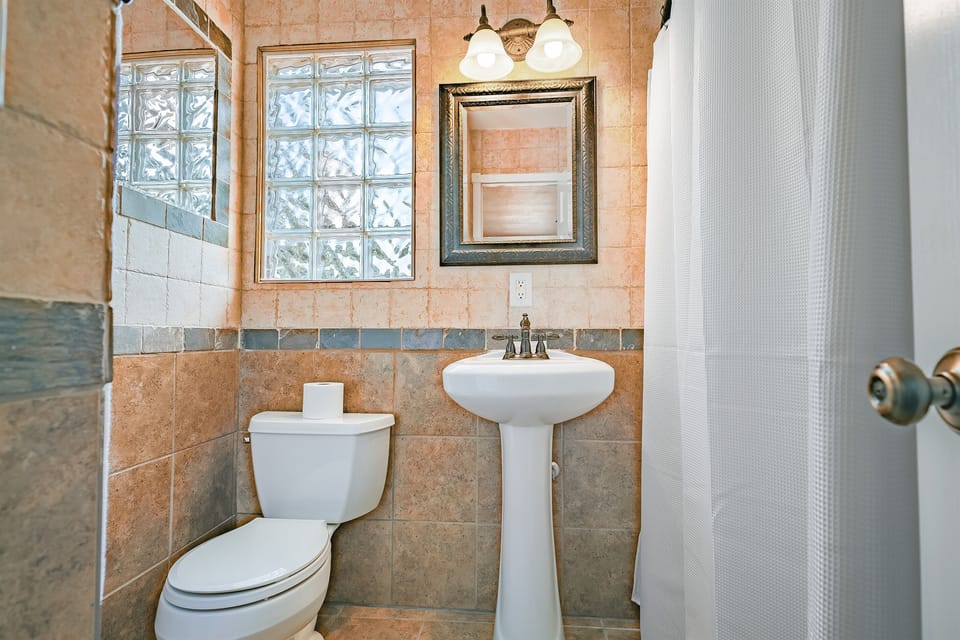 The sleek, modern bathroom offers a bright and peaceful space to start or end your day with ease.