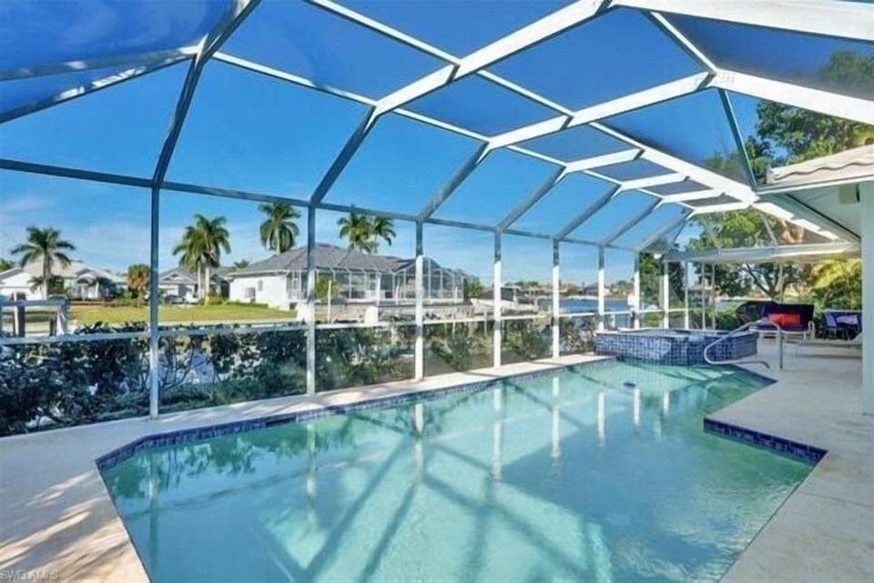 Relax and enjoy Heated Pool with canal view