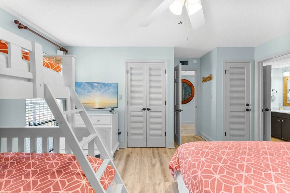 This spacious bedroom features a queen bed and twin-over-full bunk beds—perfect for families or groups