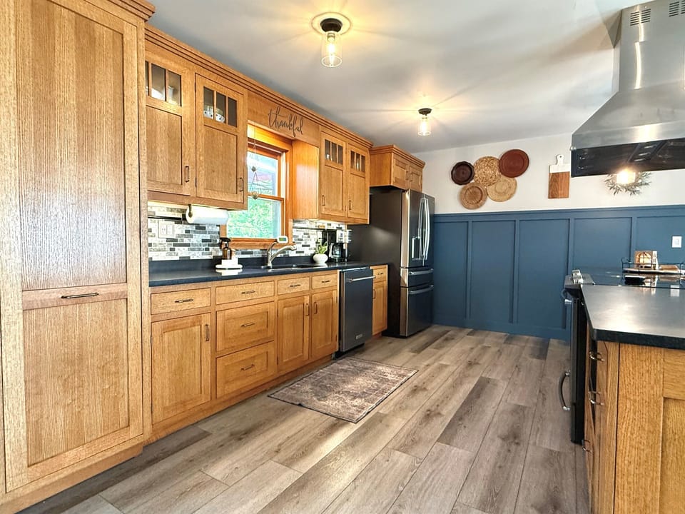 The kitchen cupboards and drawers are filled with all the necessities to cook meals right at the house! A large pantry is left open to make storing your groceries easy and accessible! 