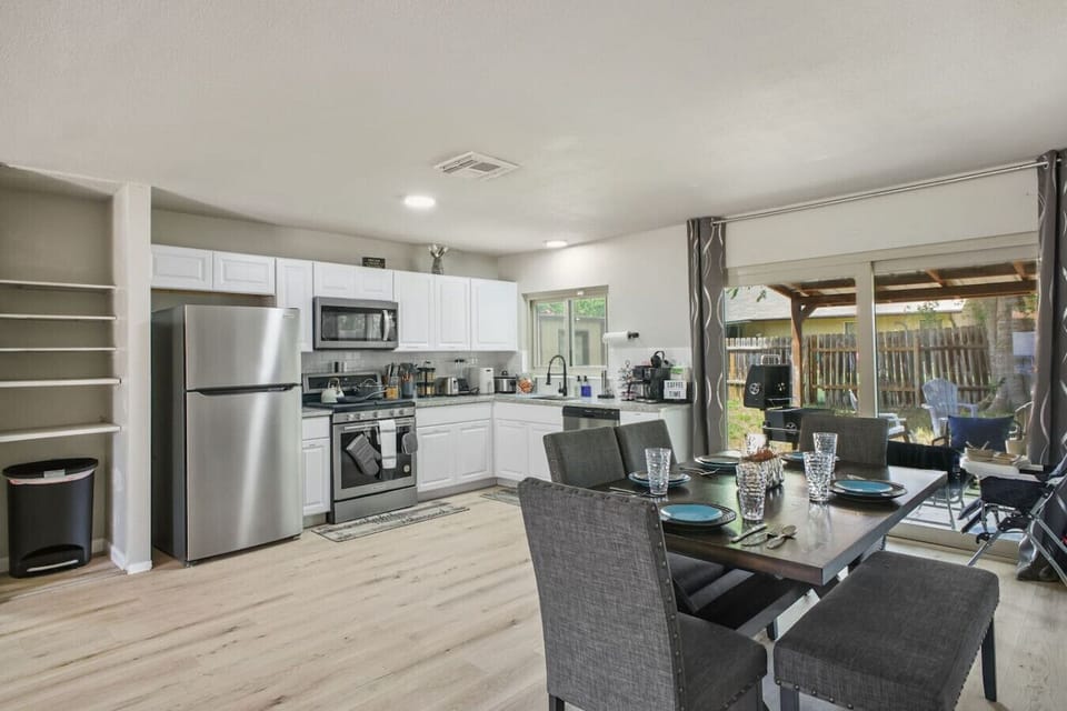 Bright and modern kitchen with stainless steel appliances and a spacious dining area. Perfect for cooking meals and gathering with friends or family.