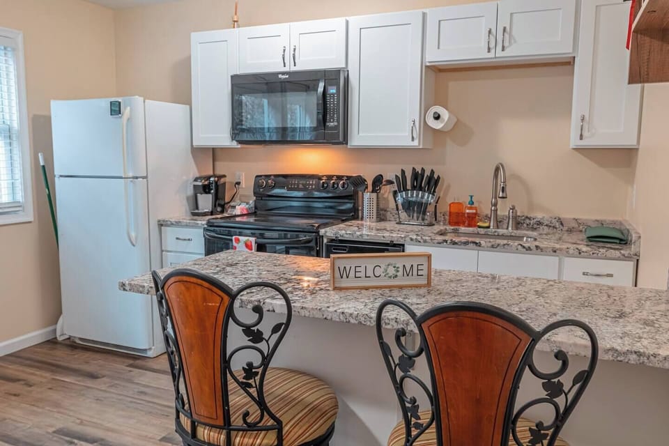 Contemporary kitchen design complemented by a versatile bar counter area.