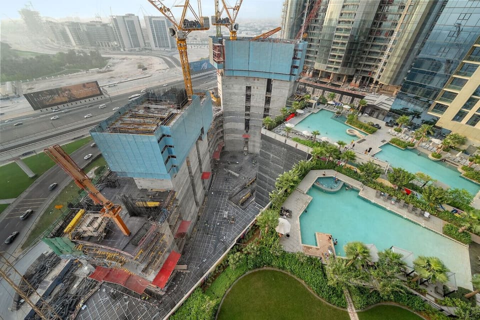 City View: Witness Dubai’s stunning skyline with lively construction and serene pools below!