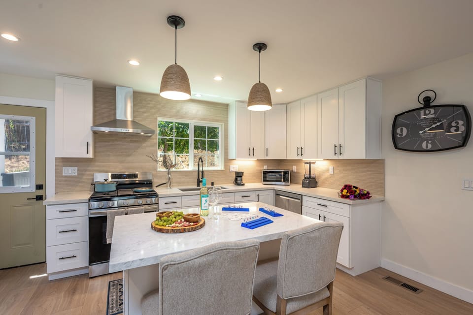 Bright kitchen with large pendant lighting, and plenty counter space.