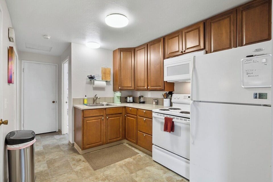 Full kitchen with plenty of cabinets. Has a full-size fridge and stove. 