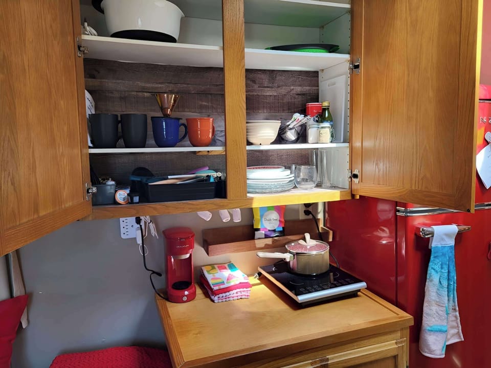 Kitchen is equipped with an induction hotplate, a coffee station and cooking equipment.