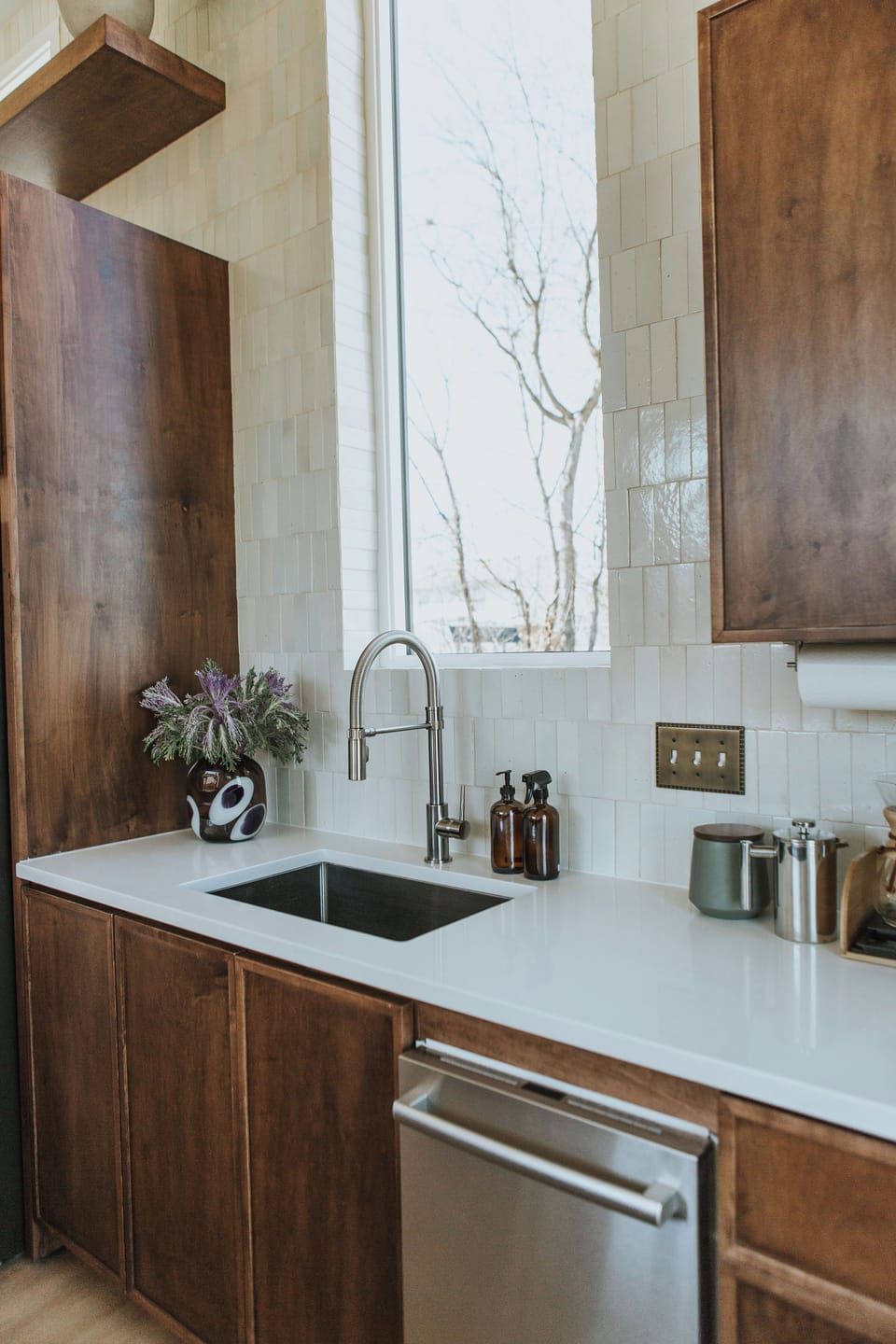 Kitchen sink beneath 7' window and tile wall