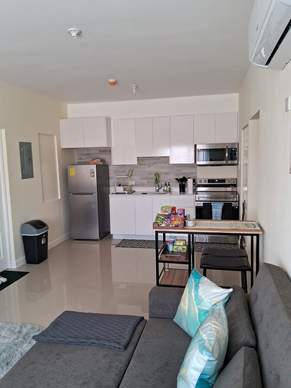 Full kitchen with refrigerator, stove and microwave