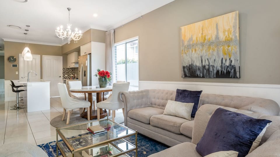 A statement chandelier and vibrant artwork bring comfort and style together