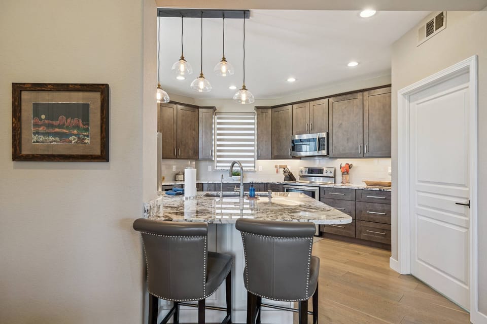 Nice size kitchen with 4 barstools at the counter & there is a desk with a chair