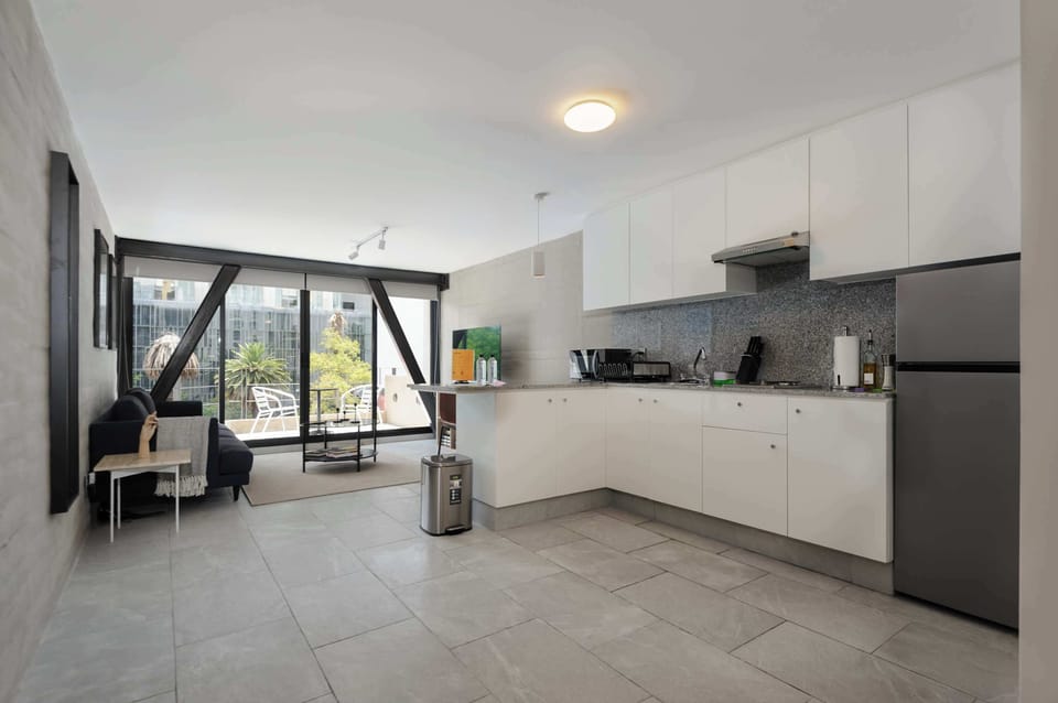 Bright living area with floor-to-ceiling windows.

