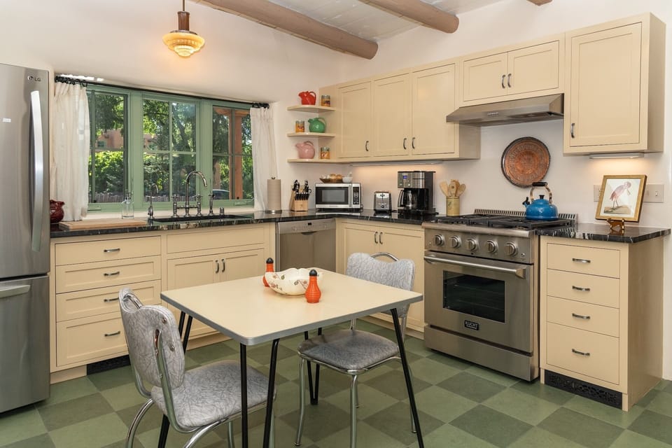 Chef's kitchen is fully stocked with appliances and cooking staples