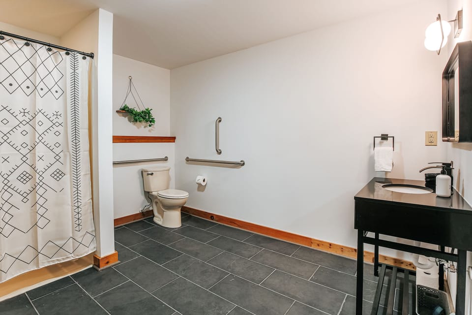 Spacious bathroom with walk-in shower and accessibility features.