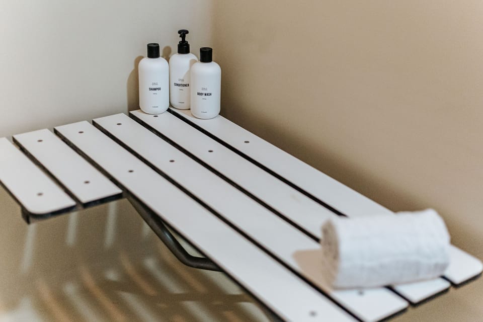The accessible walk-in shower comes with a fold-down bench and luxury amenities.