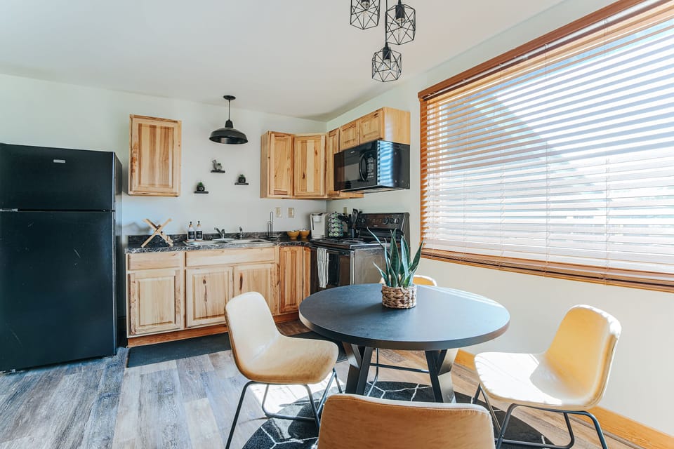 Cozy kitchen with natural wood cabinets and sleek appliances.