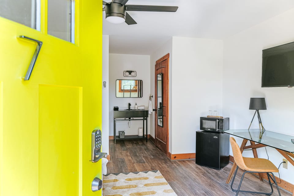 Modern comfort starts at this suite’s vibrant entrance and stylish workspace.