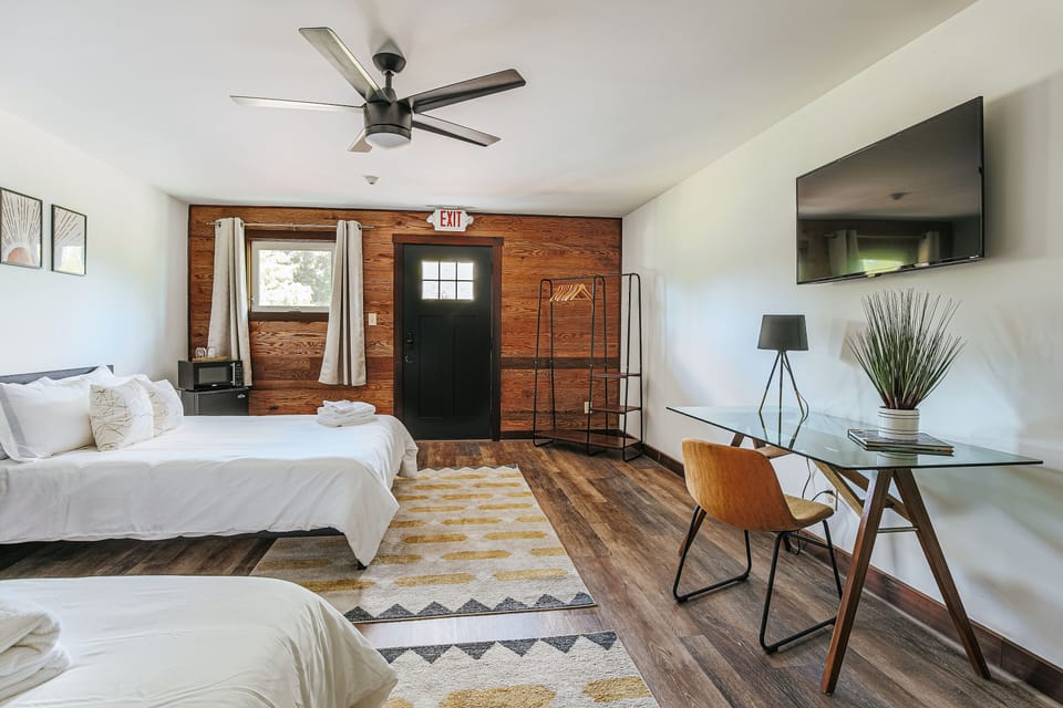 Spacious 2-queen studio with work desk and kitchenette for comfort.