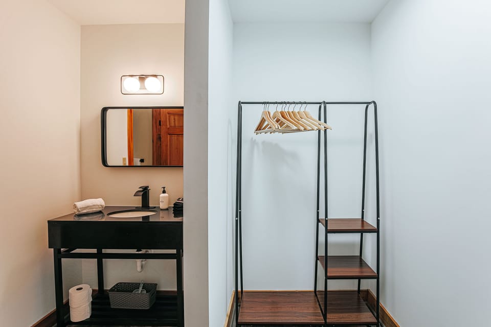 Dressing area comes with a stylish hanging rack and ample shelving.