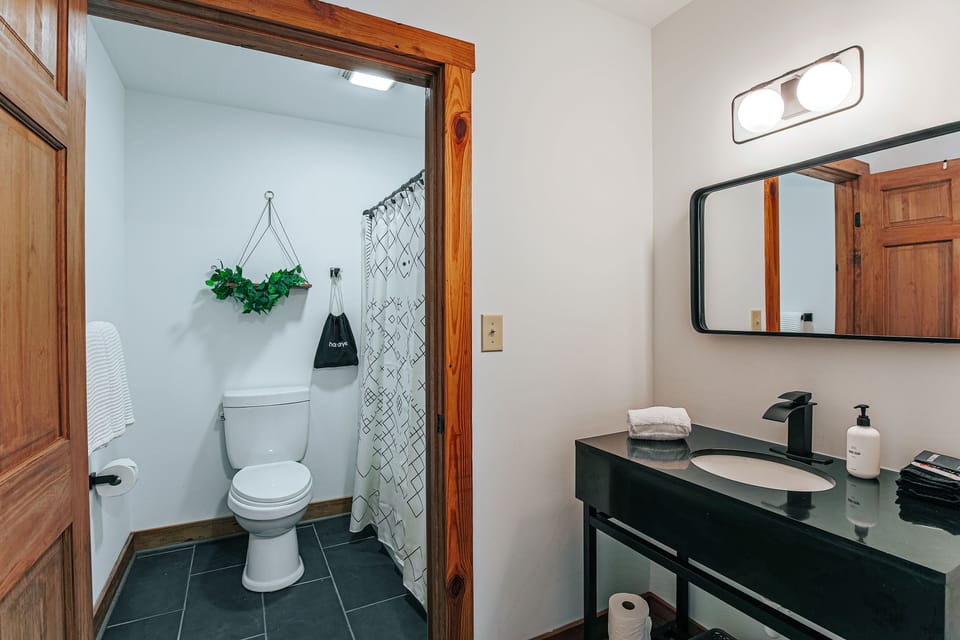 Modern bathroom with spacious vanity and essentials for relaxation.