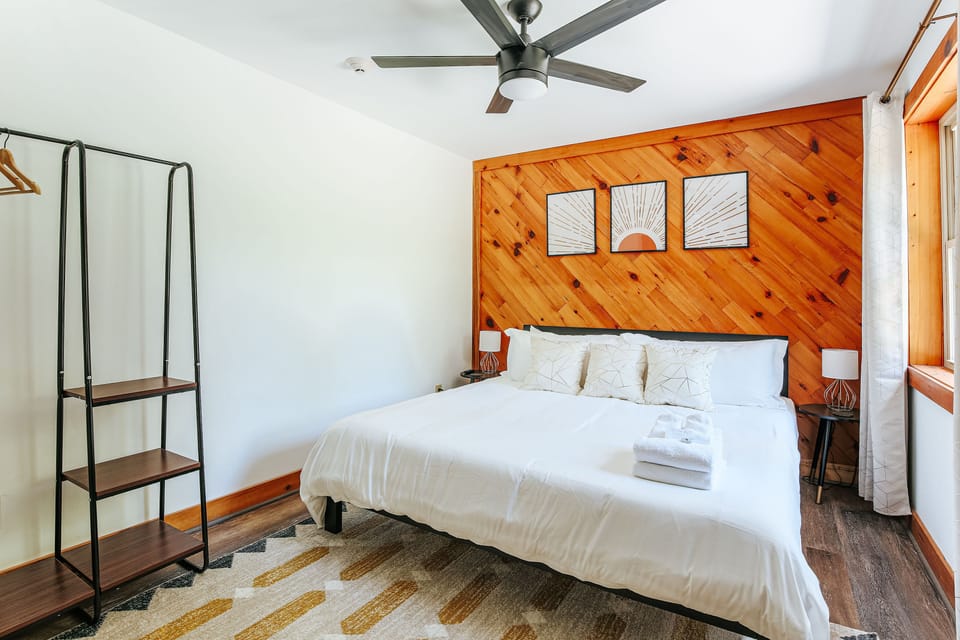 Inviting king bedroom with stylish decor and ample storage.