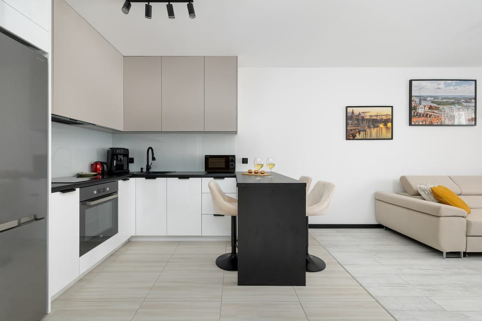 L-shaped kitchen connected to the living room with a center island.