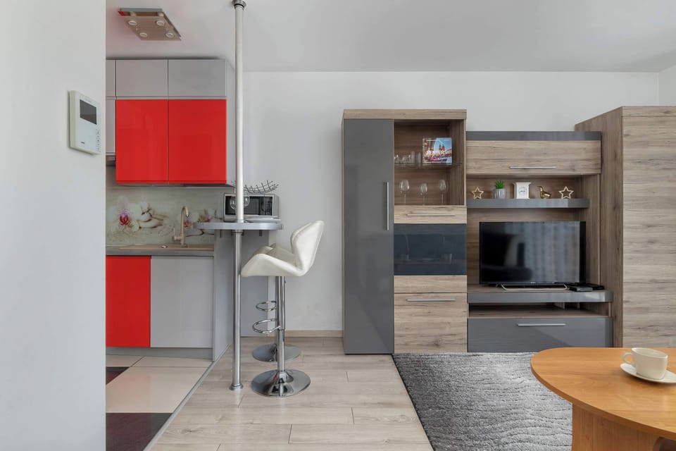 Dining area with red accents – Functional space for meals and gatherings.