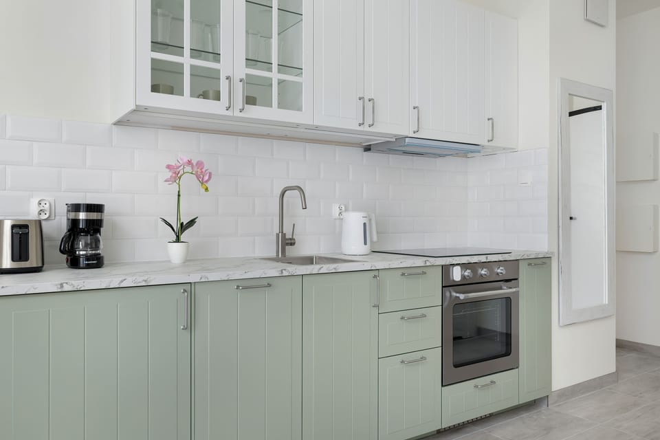 The sleek design of the kitchenette blending seamlessly with the living area.