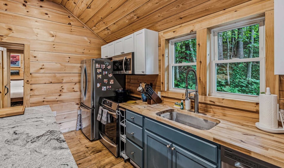 Kitchen and island from the dining area with vaulted pine ceiling