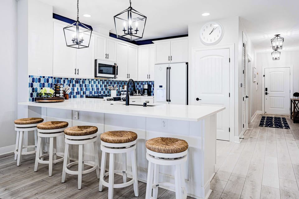 Sleek island seating adds style and function to this fully equipped kitchen.