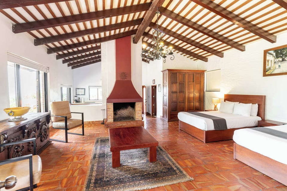 Bedroom 2 | Two double beds, living room, kitchen, Smart TV, indoor fireplace, and garden views