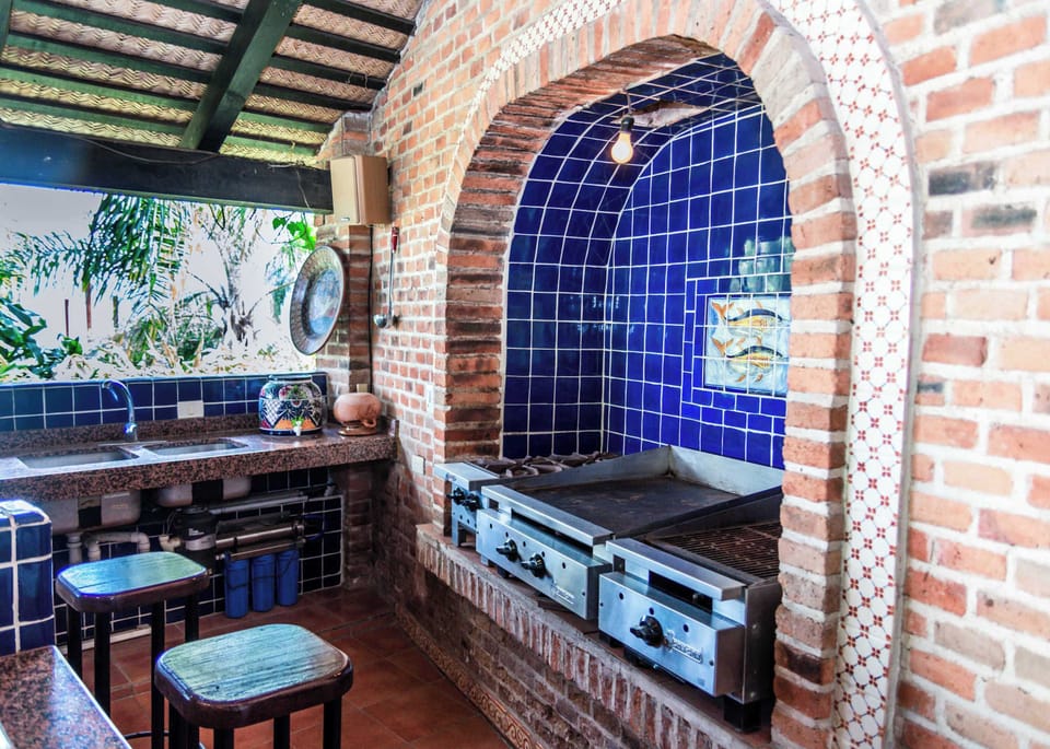 Outdoor Kitchen | Fully equipped kitchen with Mexican parrilla for al fresco dining