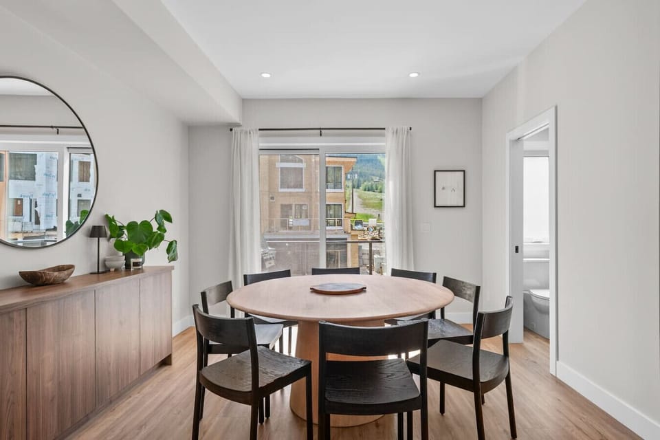 Dining table with seating for 8 and access to the second balcony with outdoor seating and a BBQ.
