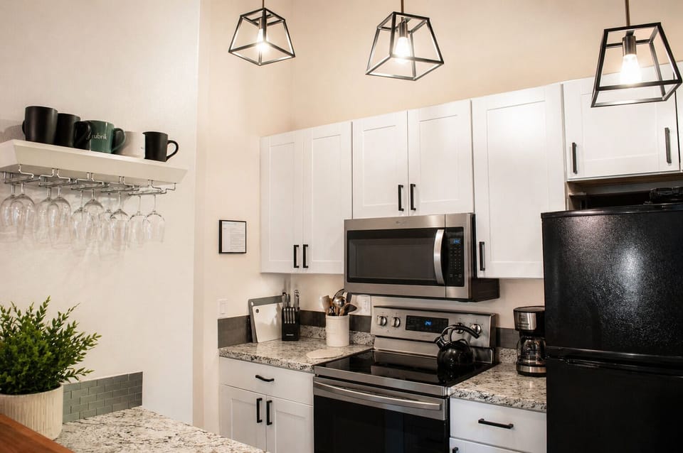 Your bright modern kitchen awaits with granite counters, stainless appliances, and stylish pendant lighting for memorable meals.