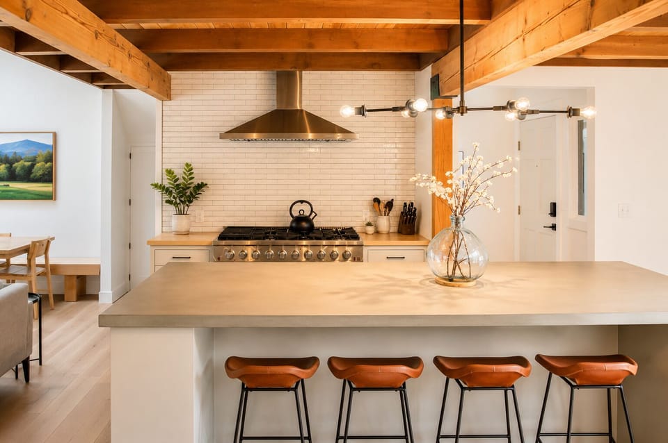 Picture yourself preparing meals in this stunning chef's kitchen, where exposed beams meet modern design. The spacious island invites you to gather, cook, and create memories in comfort.