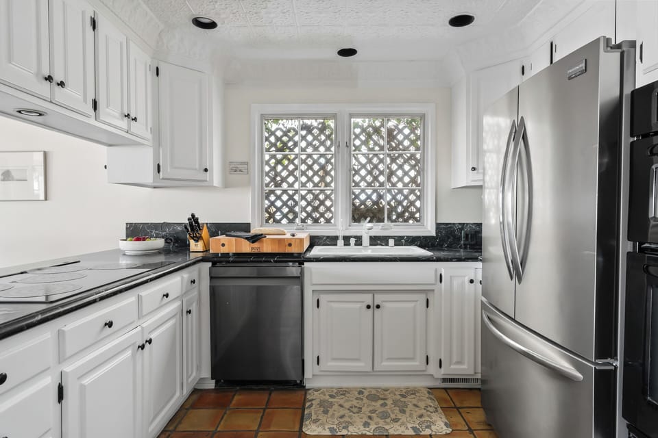 Bright kitchen with white cabinetry and modern finishes.