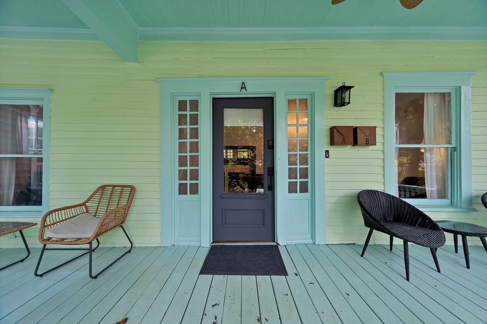 Welcoming front entry w/ double glass doors, soft lighting & cozy seating