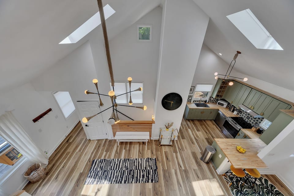 Dramatic vaulted ceilings & loft overlook bring light & openness to the main living space