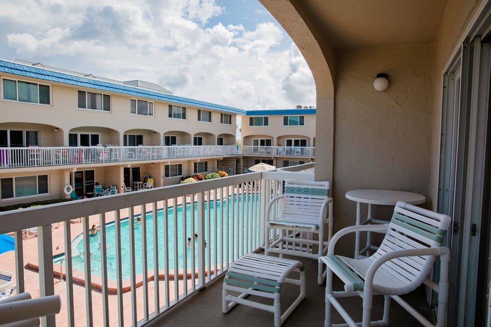 Relax on your private balcony overlooking the sparkling pool, the perfect spot to sip your morning coffee or unwind after a day of beachside fun.
