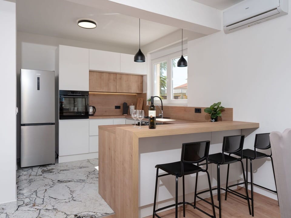Furniture, Countertop, Kitchen, Interior Design, Flooring, Cabinetry, Floor, Light Fixture, Wall, Kitchen Appliance