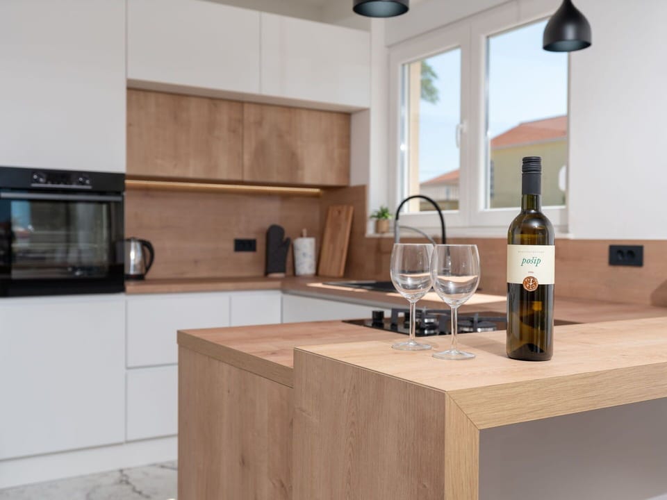 Furniture, Kitchen, Flooring, Interior Design, Countertop, Wood, Cabinetry, Floor, Kitchen Appliance, Room