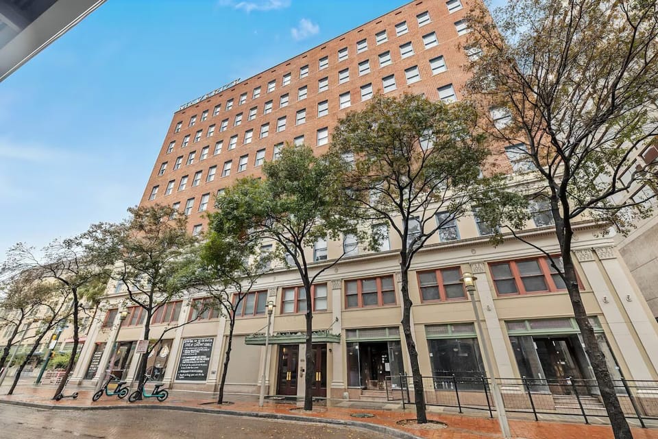 Explore the neighborhood from a classic building on a tree-lined street.