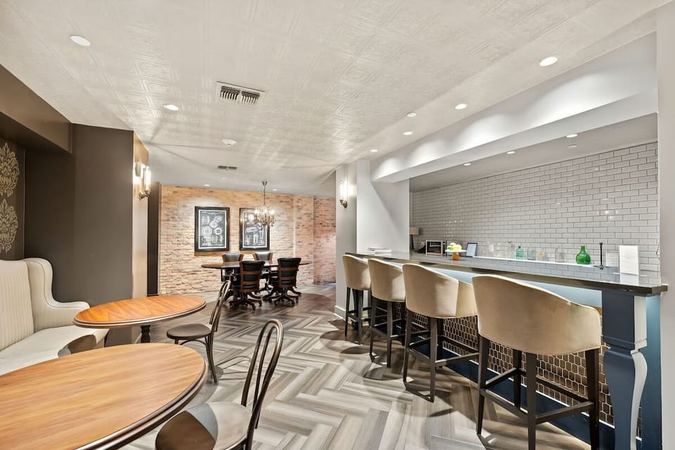 Gather for drinks at the sleek bar with cozy seating.