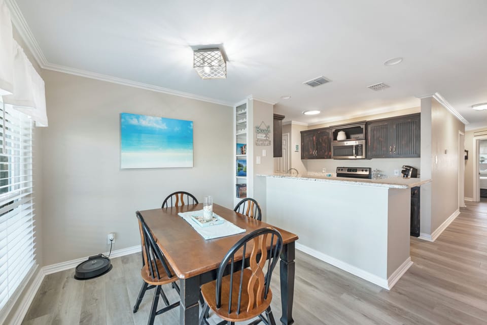 Gather around your spacious dining table, perfectly positioned next to the open kitchen for effortless entertaining and memorable meals together.