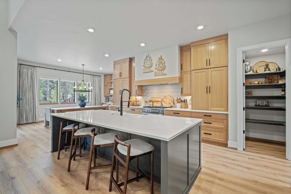 Your spacious kitchen invites culinary adventures with warm wood cabinets, gleaming countertops, and a generous island for gathering with loved ones.